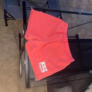 Orange Nike shorts, M